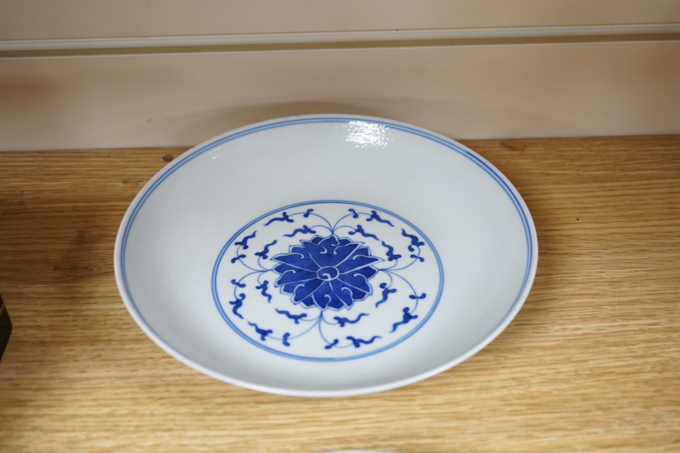 A Chinese blue and white dish and a similar enamelled dish, largest 20cm